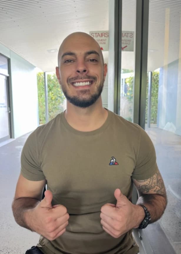 Jared, founder of Metamorph Supports, smiling with both thumbs up.